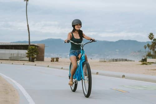 A woman riding a bicycle as one of the travel hacks for women